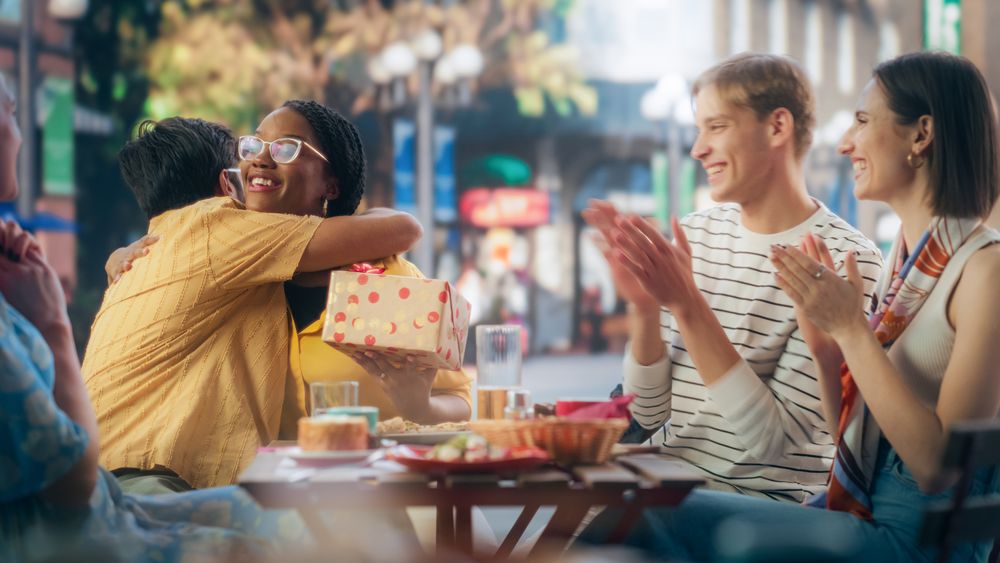 Friends Gathered to Celebrate a Birthday Event in a Street Cafe.