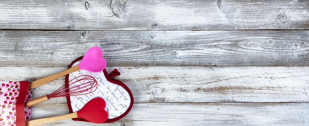 Valentine’s day with cooking utensils on aged wood
