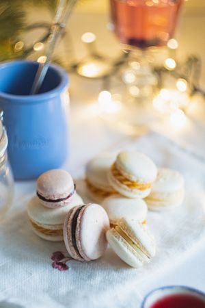 Festive macarons on table with string lights