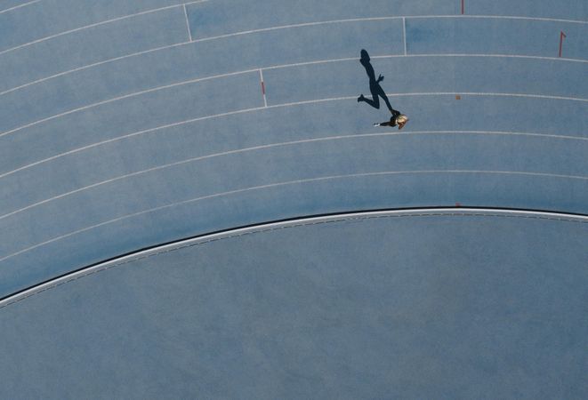 Aerial view of a woman athlete running on athletic track