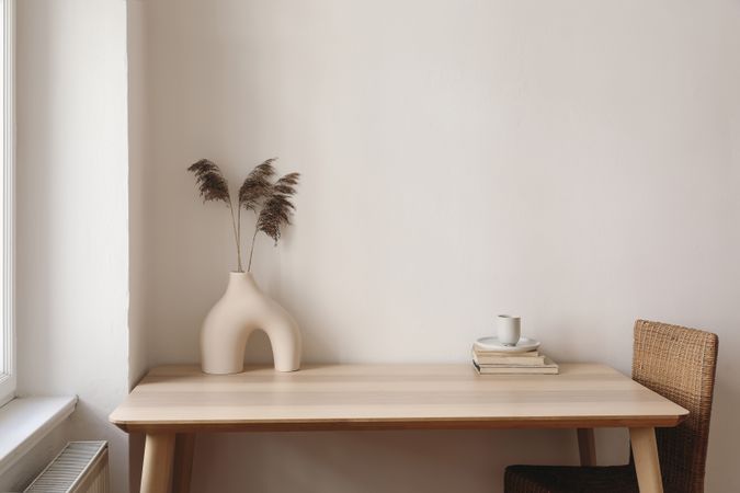 Table with modernist vase and decorative reeds