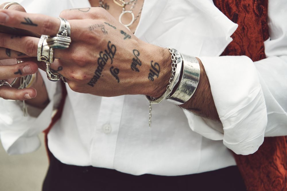 London, England, United Kingdom - September 18 2021: Close up of man’s tattood hands