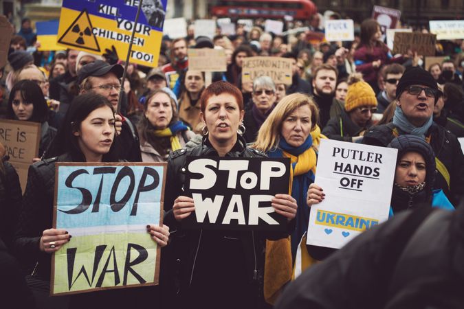 London, England, United Kingdom - March 5 2022: Group of people at forest with “Stop War” signs