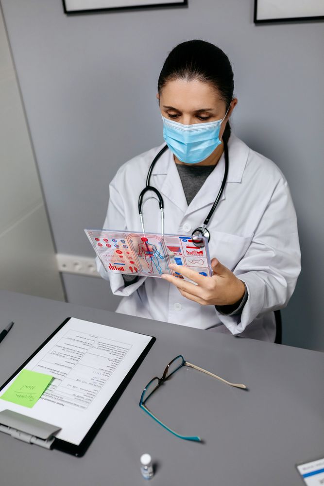 Female doctor looking at transparent tablet with medical digital diagnostic screen