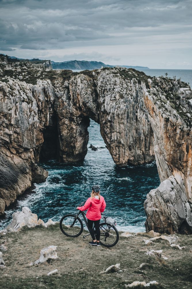 Female bicyclist on rocks