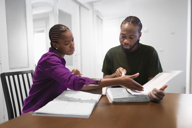 Casual Study Session at Home with Books and Conversation.