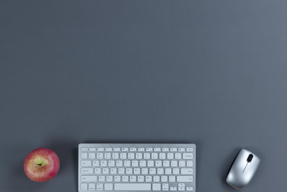 Working gray desktop with apple fruit and technology plus copy space