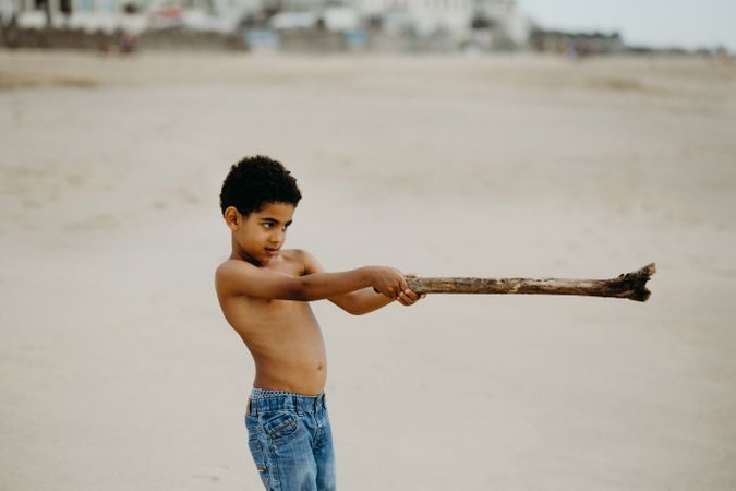 Black boy playing on beach