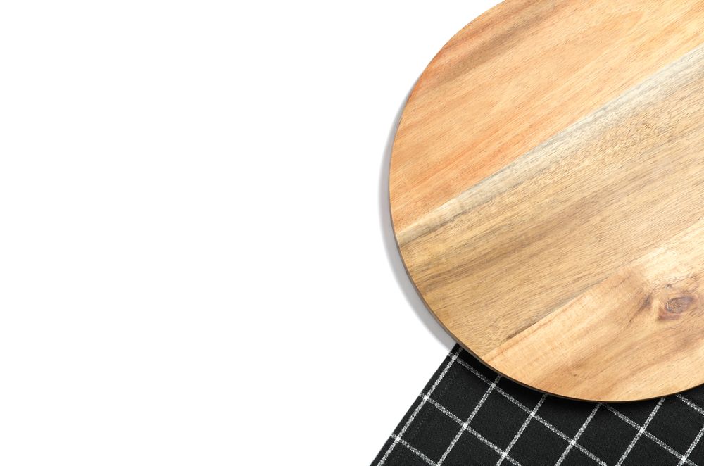 Cutting board with kitchen towel isolated on plain background, top view
