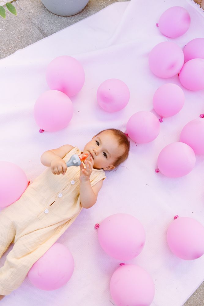 Cute baby on lying with colorful balloons