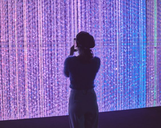 Tokyo, Japan - November 19th, 2019: Young woman taking a photo of an art installation