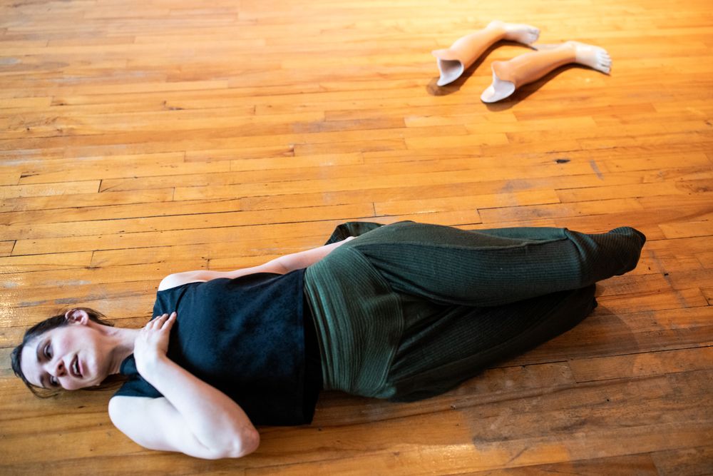 MONTREAL, QUEBEC, CANADA – April 19 2019-Woman lying on floor with her prosthetic legs removed