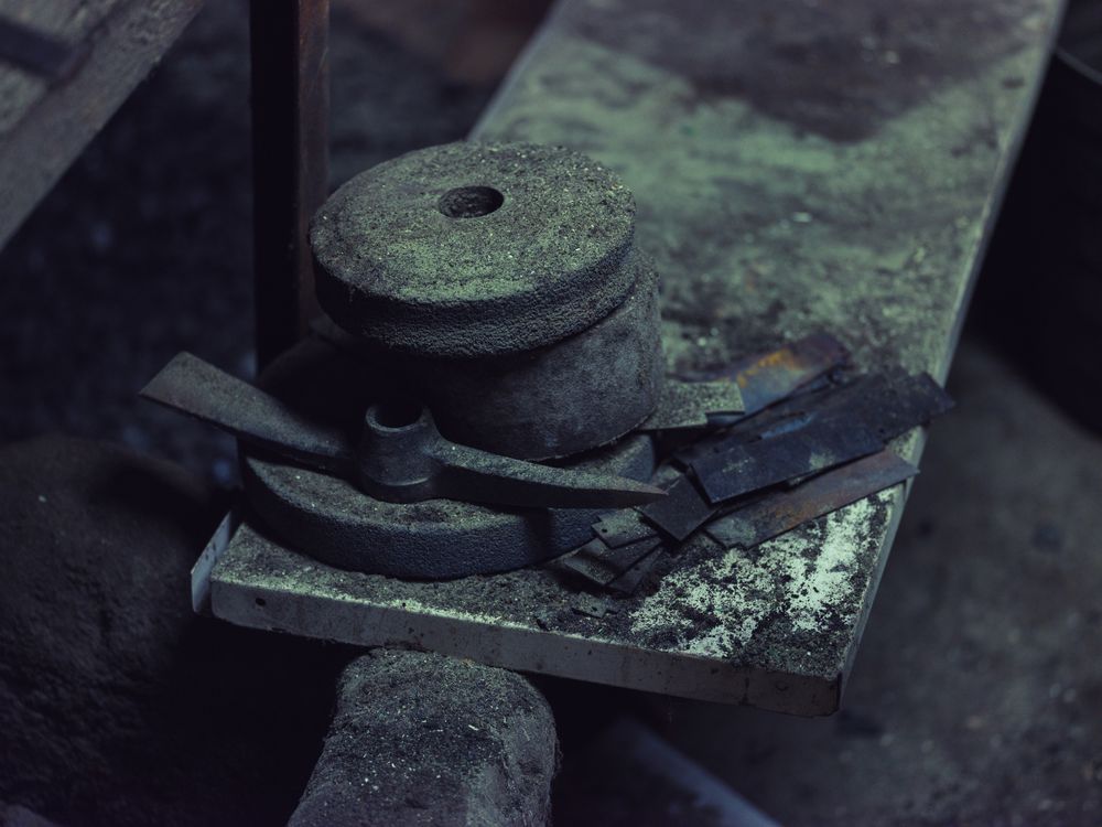 Metal parts on anvil in blacksmith workshop