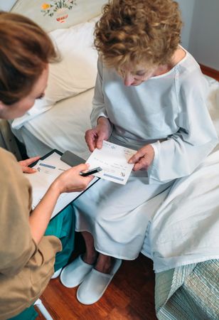 Doctor giving a prescription to patient