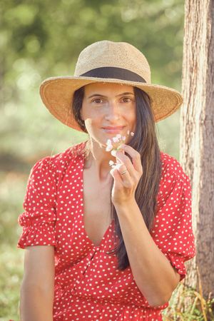 Smiling woman in hat in park