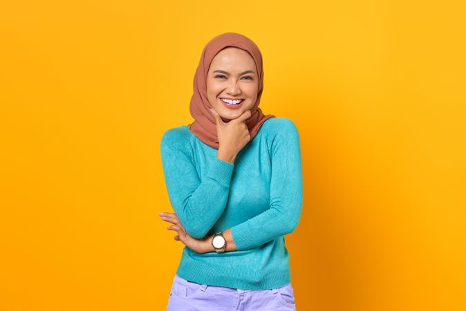 Muslim woman happy with hand on her chin