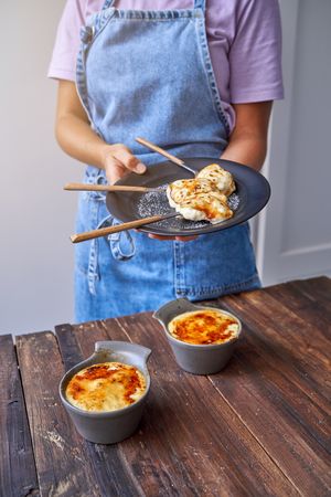 Crop woman with delicious fried dessert