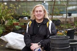 Woman smiling while sitting in garden
