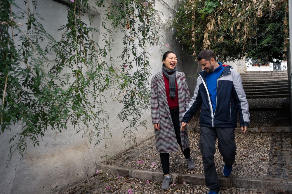 Pleased diverse couple exploring ancient town together