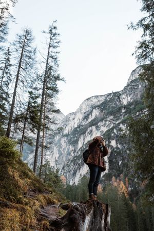 Man in amazing landscape in a autumn forest at the mountains