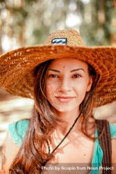 Smiling woman wearing brown straw hat 4BYYP5