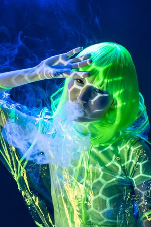 Asian woman smoking in fluorescent light