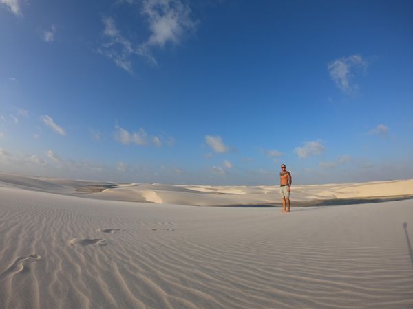 Person standing in desert under blue sky