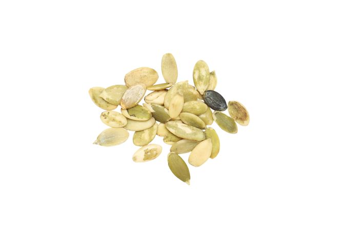 Fall season food - pumpkin seeds, isolated on blank background