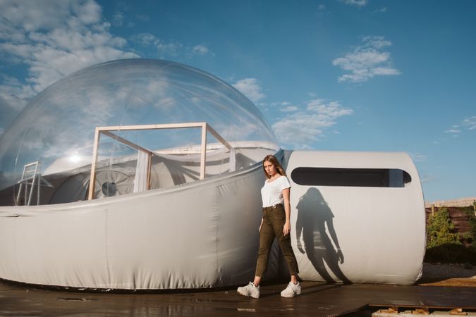 Stylish female standing near bubble hotel