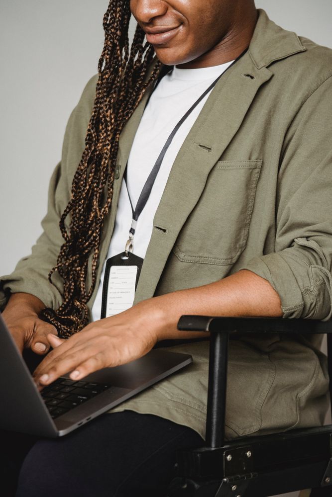 Man in gray suit jacket using laptop computer