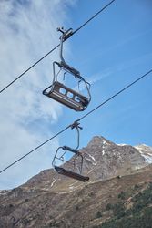 Cableway against mountain and blue sky
