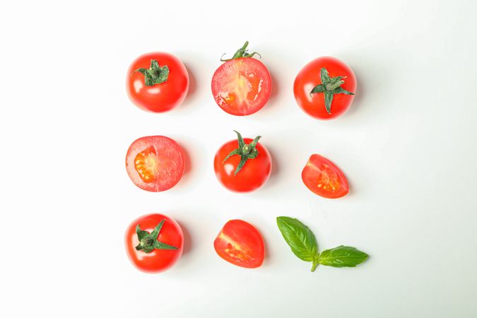 Flat lay composition with fresh cherry tomatoes and basil on blank background, space for text. Ripe vegetables