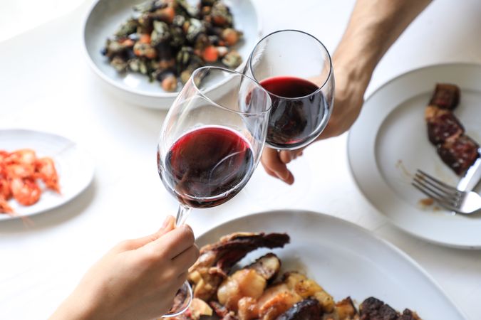 Couple cheering with red wine