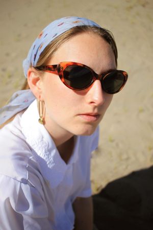 Portrait of blonde woman with headscarf and sunglasses