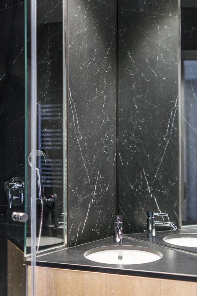 Marble sink and water tap in contemporary washroom