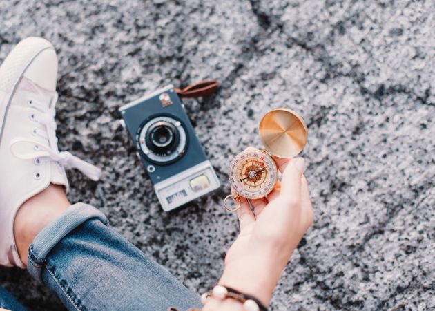 Woman with compass founding route fro photography trip