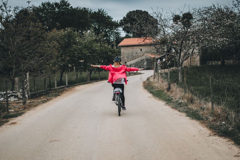 Female riding bicycle without hands