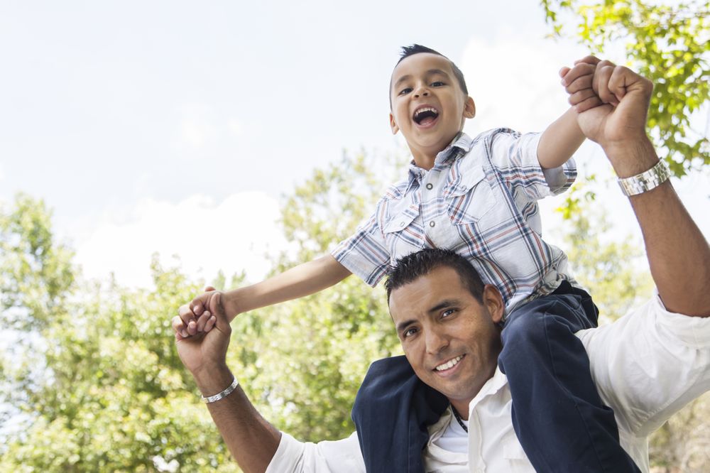 Hispanic Father and Son Having Fun in the Park