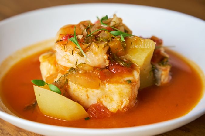 Dish of cod and prawn casserole with potatoes and palm pepper ai