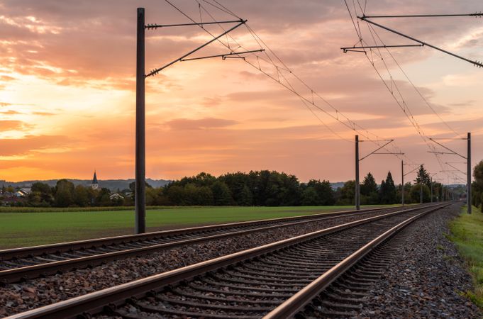 Sunrise landscape with railroad tracks in a german village