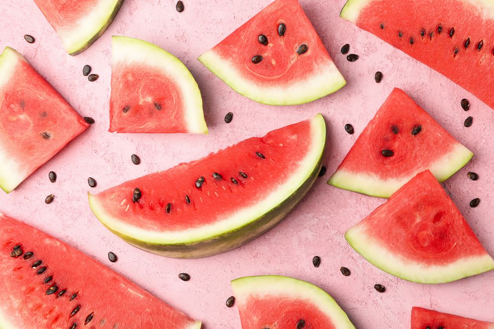 Composition with watermelon slices on pink background, top view