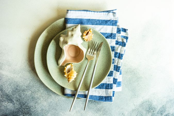 Marine table setting with sea shells on plate