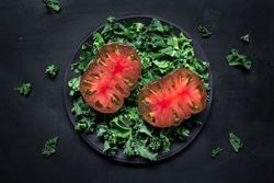 Tomatoes and lettuce leaves on plate