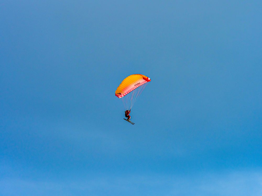 Paragliding skier, extreme sport, flying and gliding.