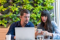Male and female having meeting in cafe