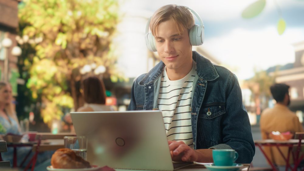 Young Stylish Freelance Designer Having an Online Conversation with a Client.