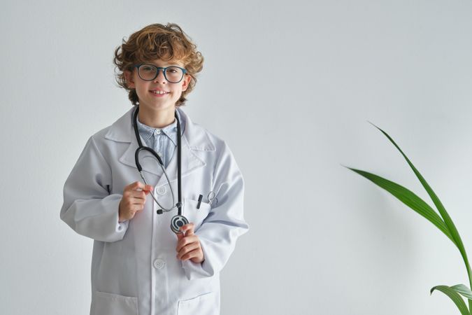 Smiling boy doctor in uniform with stethoscope