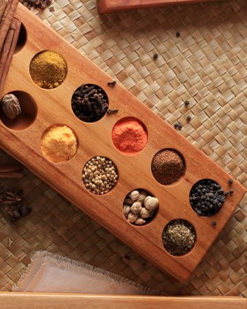 Set of Spices and herbs for cooking. Small Wooden Bowls with Colorful Seasonings and Spices.
