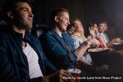 Young man with friends watching movie in cinema 5zQ2g0