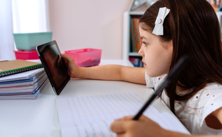 Girl doing homework with the tablet